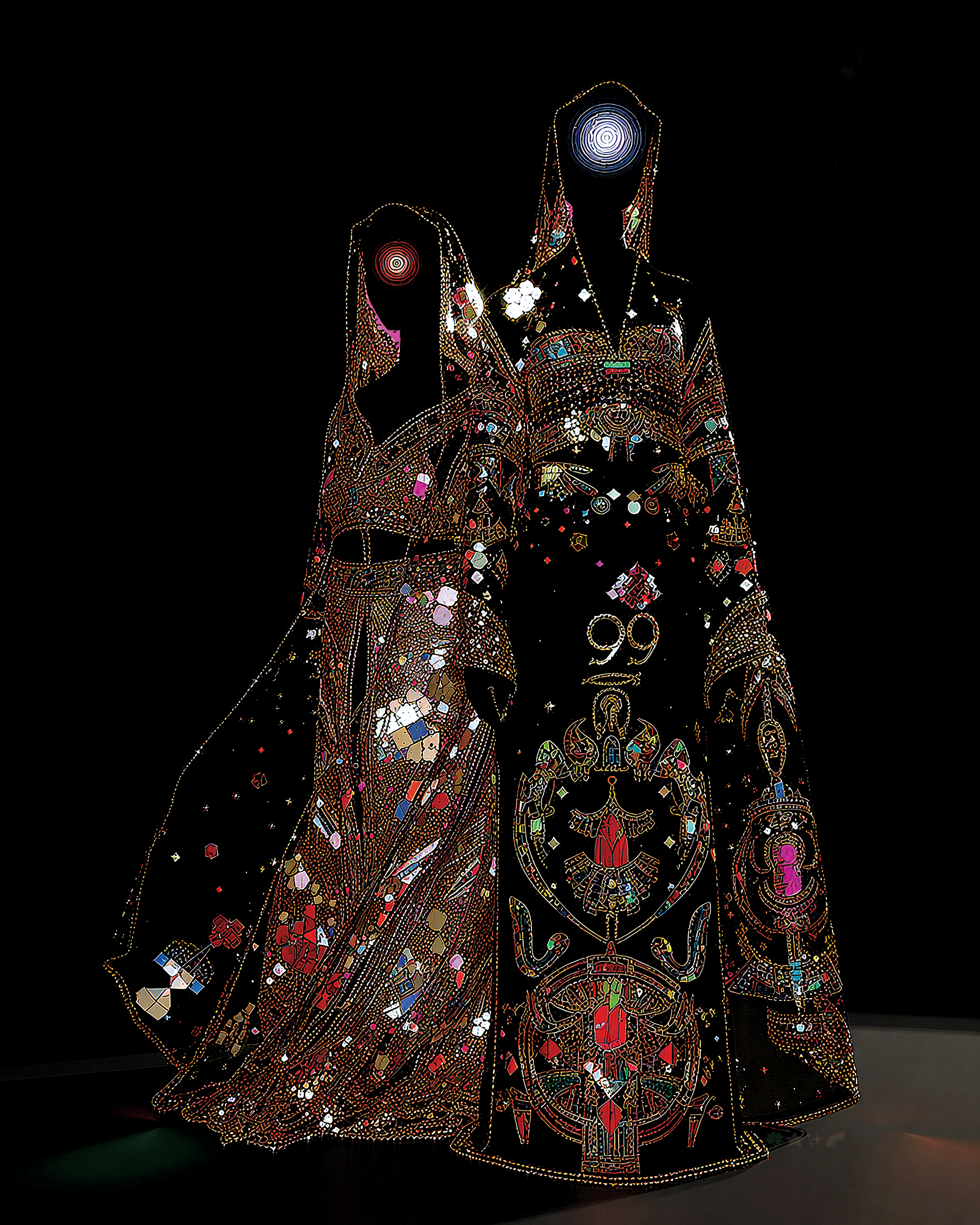 Two individuals dressed in black and gold are standing in front of a black background.